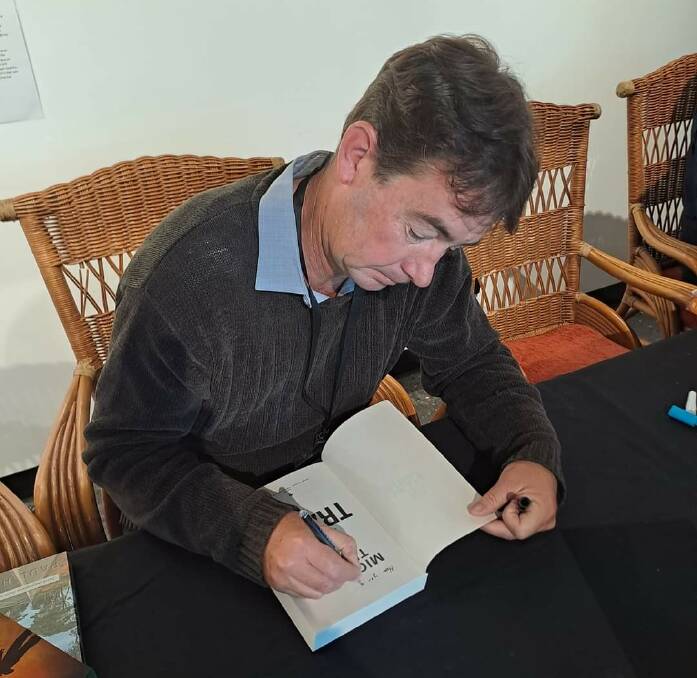  Author Michael Trant at a book signing event.
