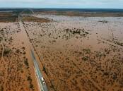 Floodwaters shown in this aerial view of the Nullarbor have now receded, the train line can be seen at the right of ARTC's picture adjacent to the highway.
